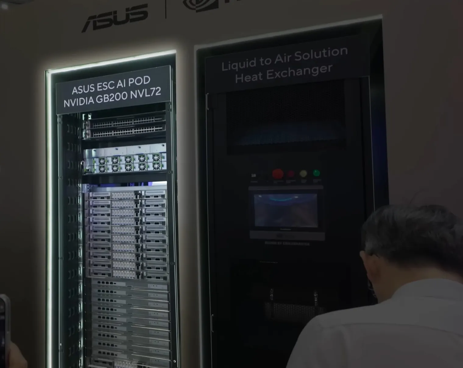 An NVIDIA GB200 NVL72 rack system on display beside a liquid-to-air heat exchanger cabinet.