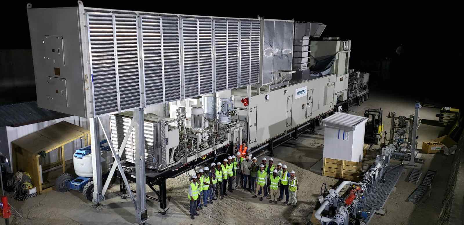 A trailer-mounted mobile aeroderivative gas turbine unit installed at a power plant.